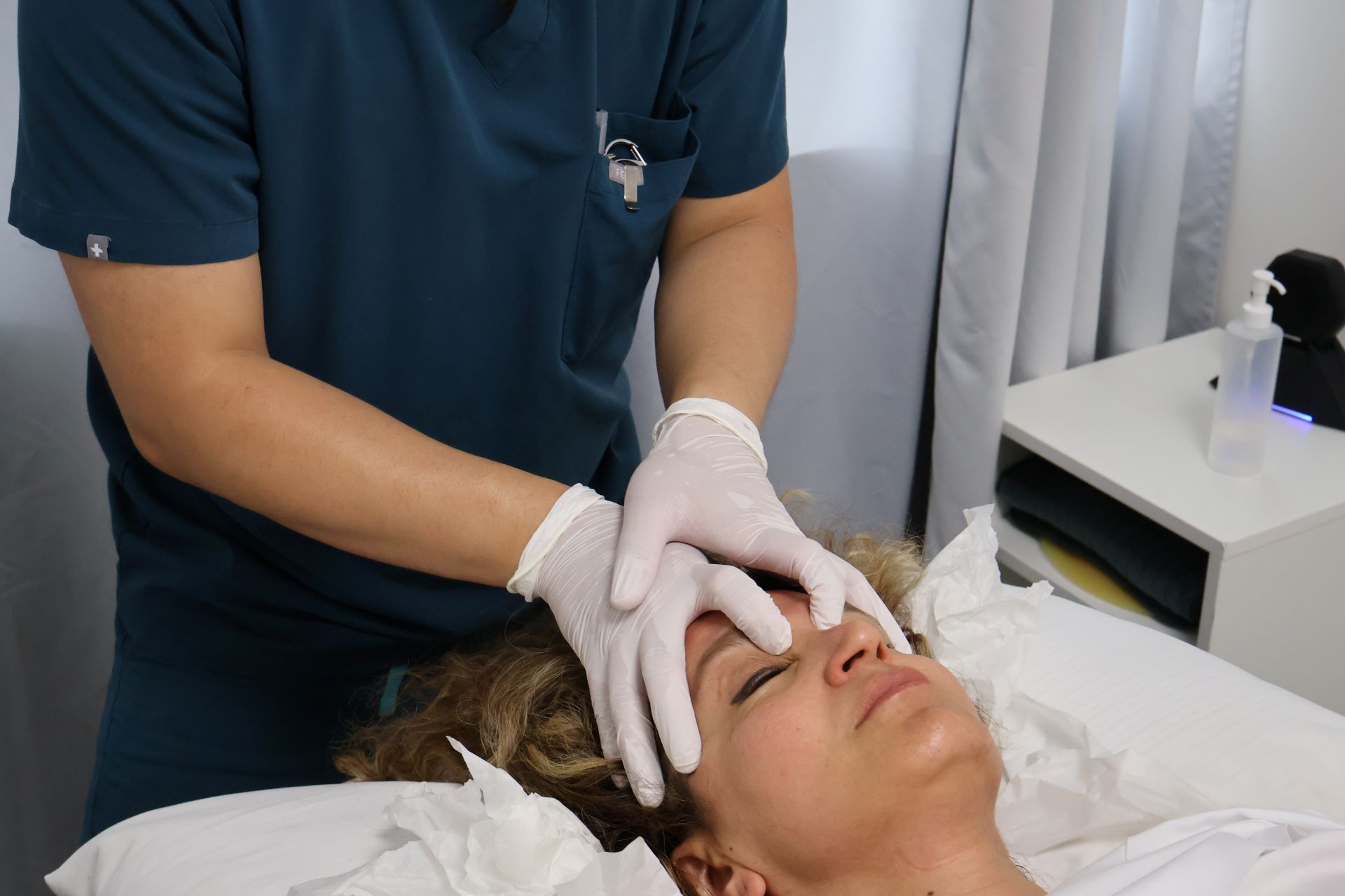 Therapist massaging a client’s face and jaw