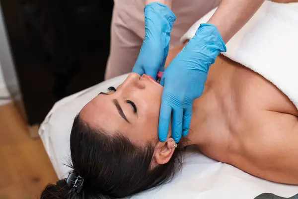 : Physiotherapist treating neck tension linked to TMJ jaw pain